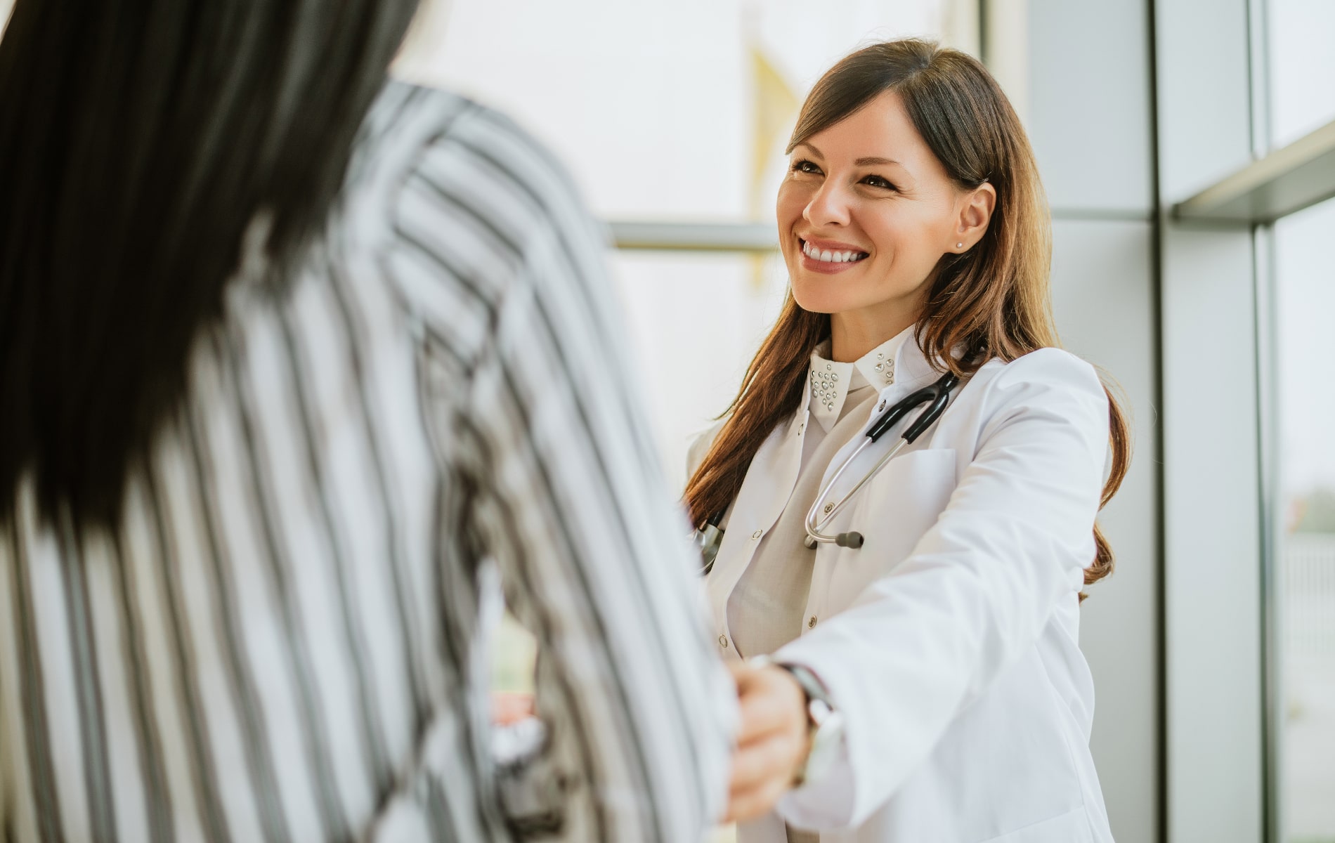 Doctor comforts patient.