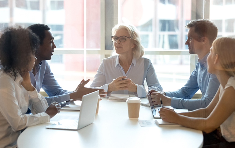 Five professionals in a Human Resources meeting.