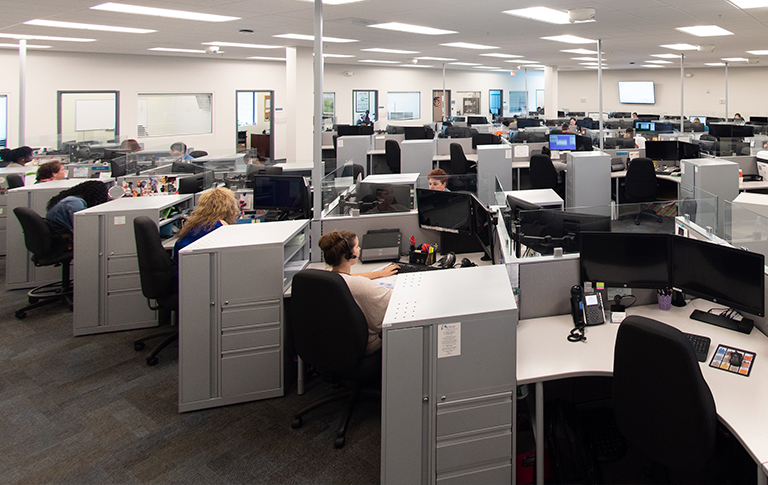 Office cubicles with busy workers.