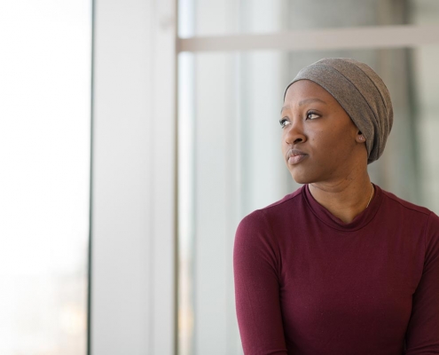 female cancer patient looking in distance - Cancer Care Cost