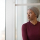 female cancer patient looking in distance - Cancer Care Cost