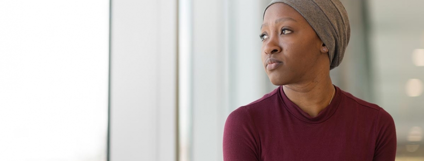 female cancer patient looking in distance - Cancer Care Cost