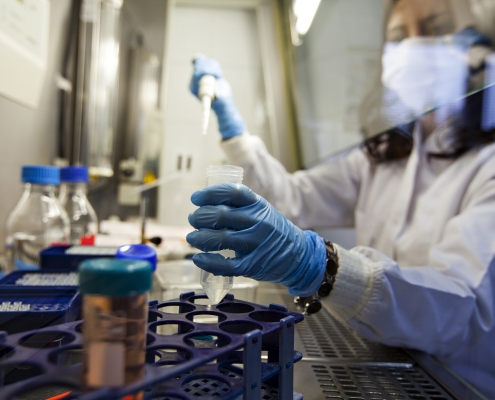 Female pharmacy team member working carefully with biosimilar drug.