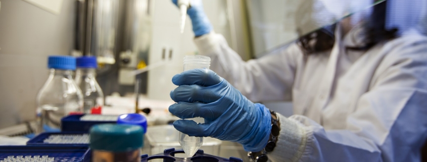 Female pharmacy team member working carefully with biosimilar drug.