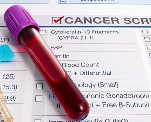 Blood test for cancer lays on medical form for cancer screening